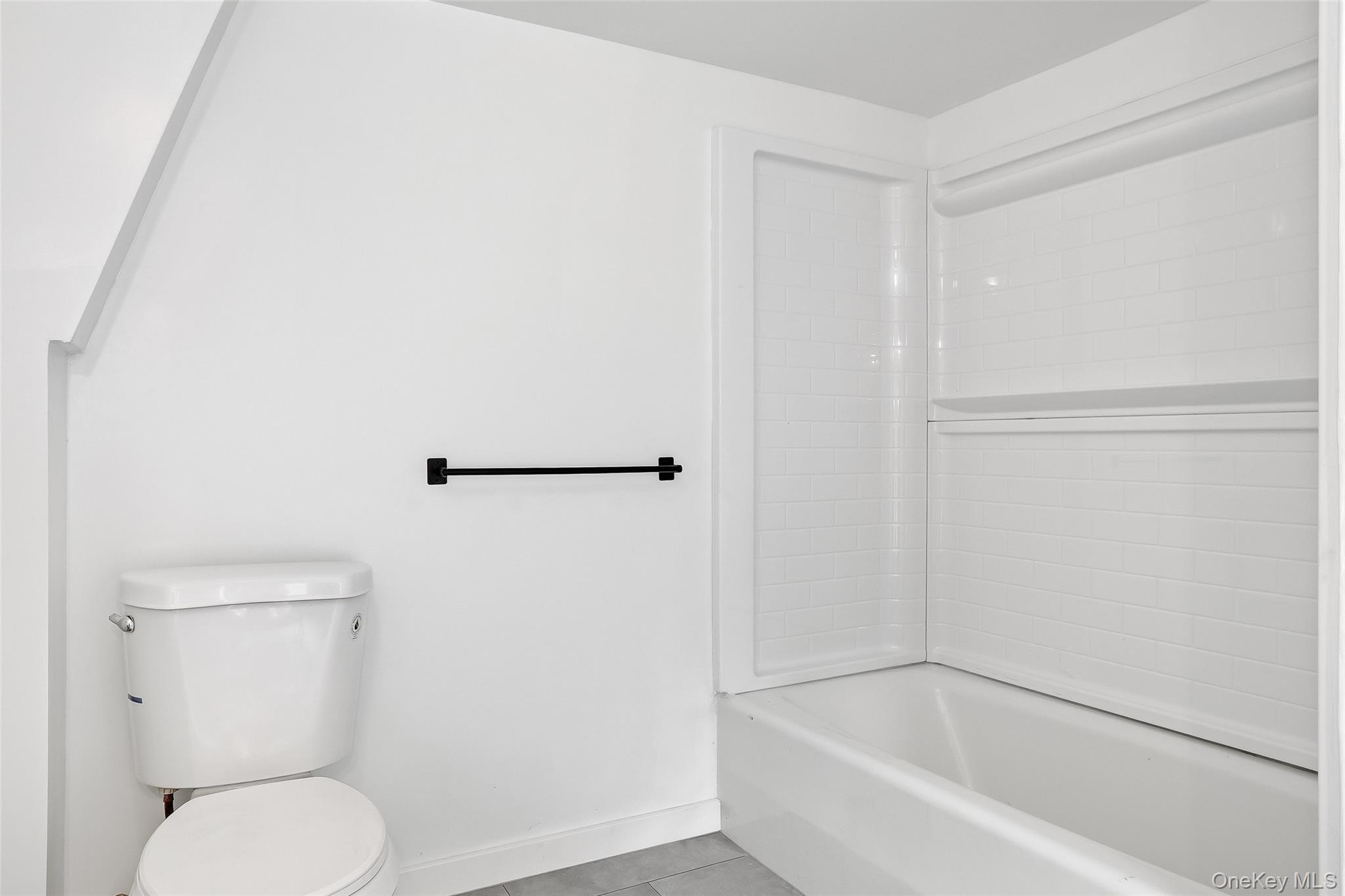 15 Ladentown Road Pomona, NY 10970 - Photo 17 of 23 a white toilet sitting next to a bath tub