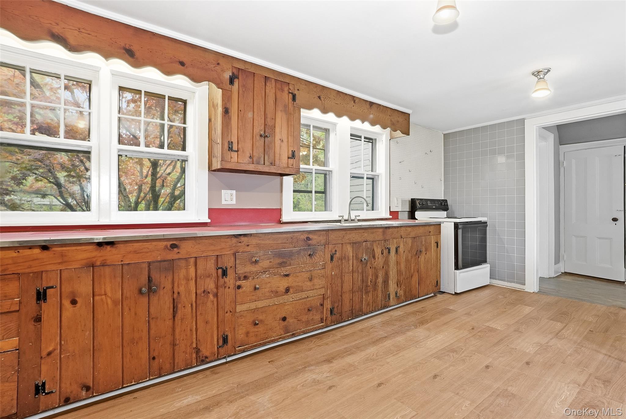 15 Ladentown Road Pomona, NY 10970 - Photo 8 of 23 a kitchen with stainless steel appliances granite countertop a sink and cabinets with wooden floor