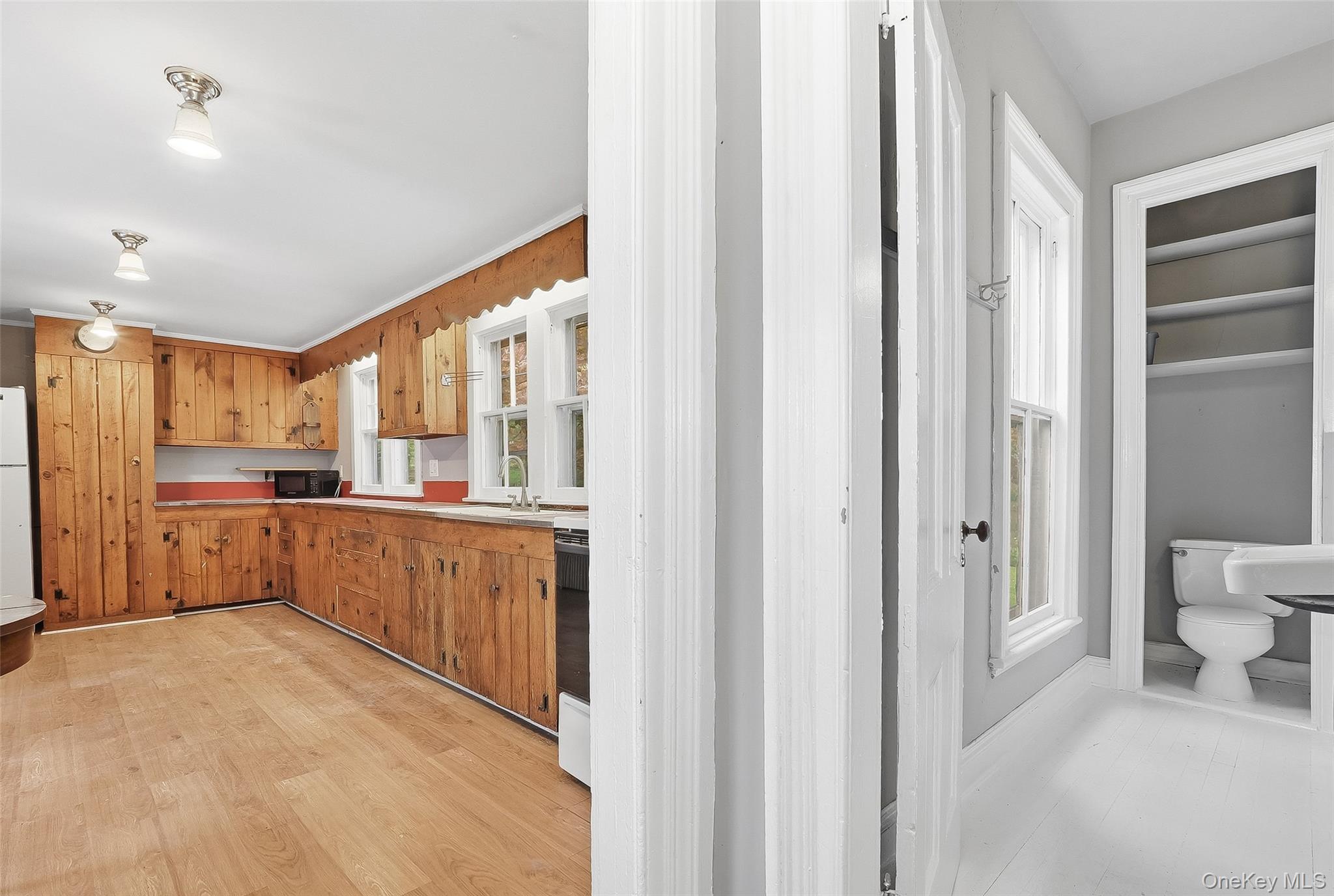 15 Ladentown Road Pomona, NY 10970 - Photo 10 of 23 a large kitchen with a refrigerator and wooden cabinets