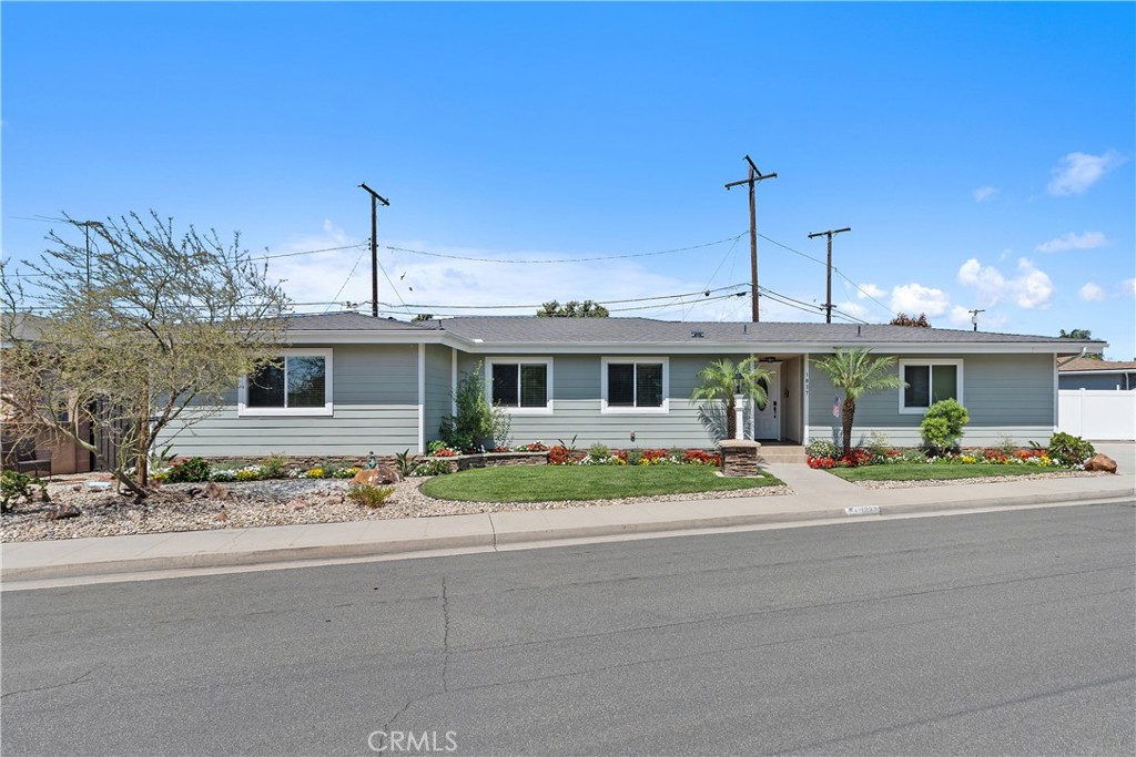 1837 North Studebaker Road Long Beach, CA 90815 - Photo 1 of 38 a front view of a house with a yard and a garage