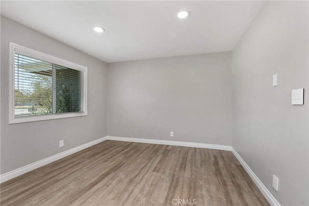 1837 North Studebaker Road Long Beach, CA 90815 - Photo 14 of 38 a view of an empty room with wooden floor and a window