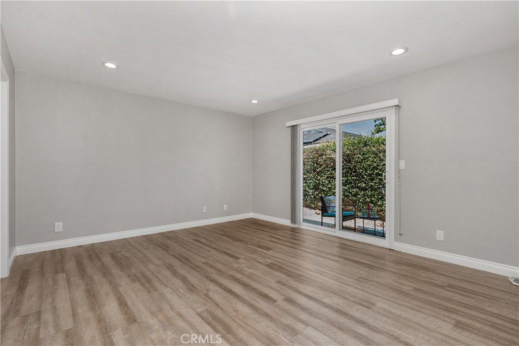 1837 North Studebaker Road Long Beach, CA 90815 - Photo 16 of 38 a view of an empty room with wooden floor and a window