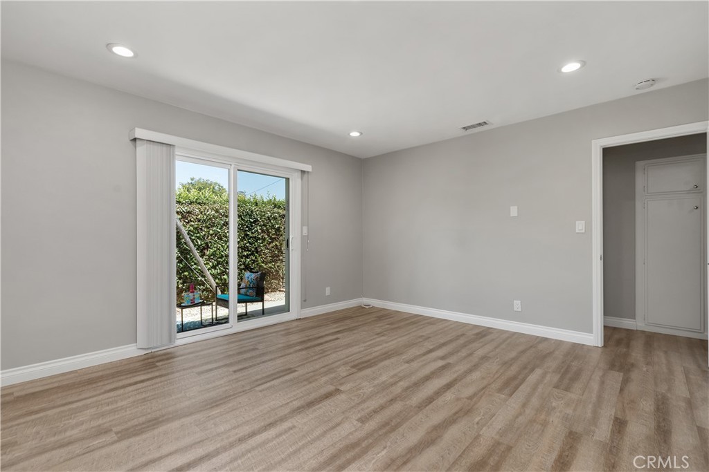 1837 North Studebaker Road Long Beach, CA 90815 - Photo 20 of 38 wooden floor in an empty room with a window