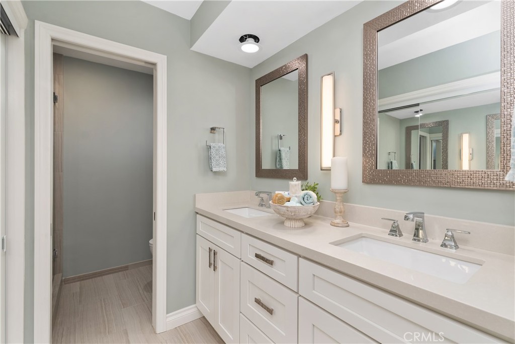 1837 North Studebaker Road Long Beach, CA 90815 - Photo 21 of 38 a bathroom with double sink and a mirror