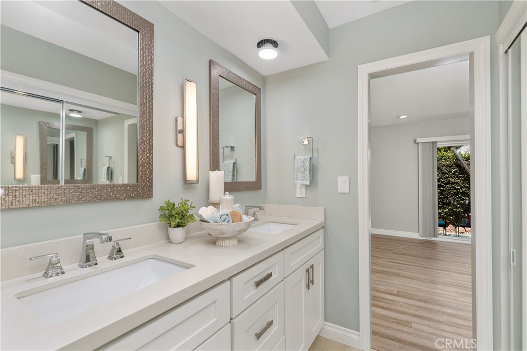 1837 North Studebaker Road Long Beach, CA 90815 - Photo 22 of 38 a bathroom with double vanity sinks and a mirror