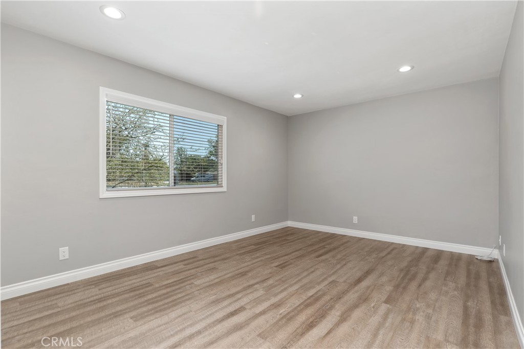 1837 North Studebaker Road Long Beach, CA 90815 - Photo 26 of 38 wooden floor in an empty room with a window