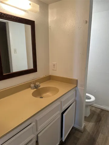a bathroom with a granite countertop sink and a mirror
