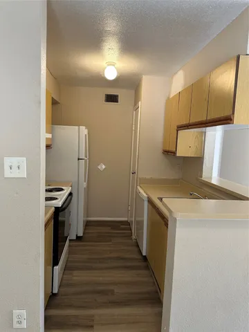 a kitchen with a sink and a stove top oven