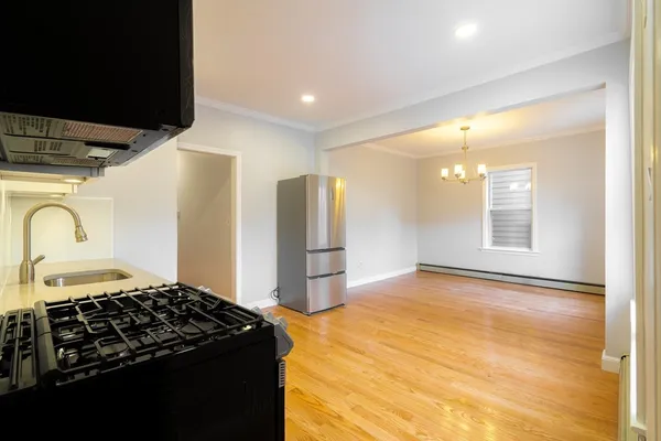 a kitchen with stainless steel appliances granite countertop a stove and a refrigerator