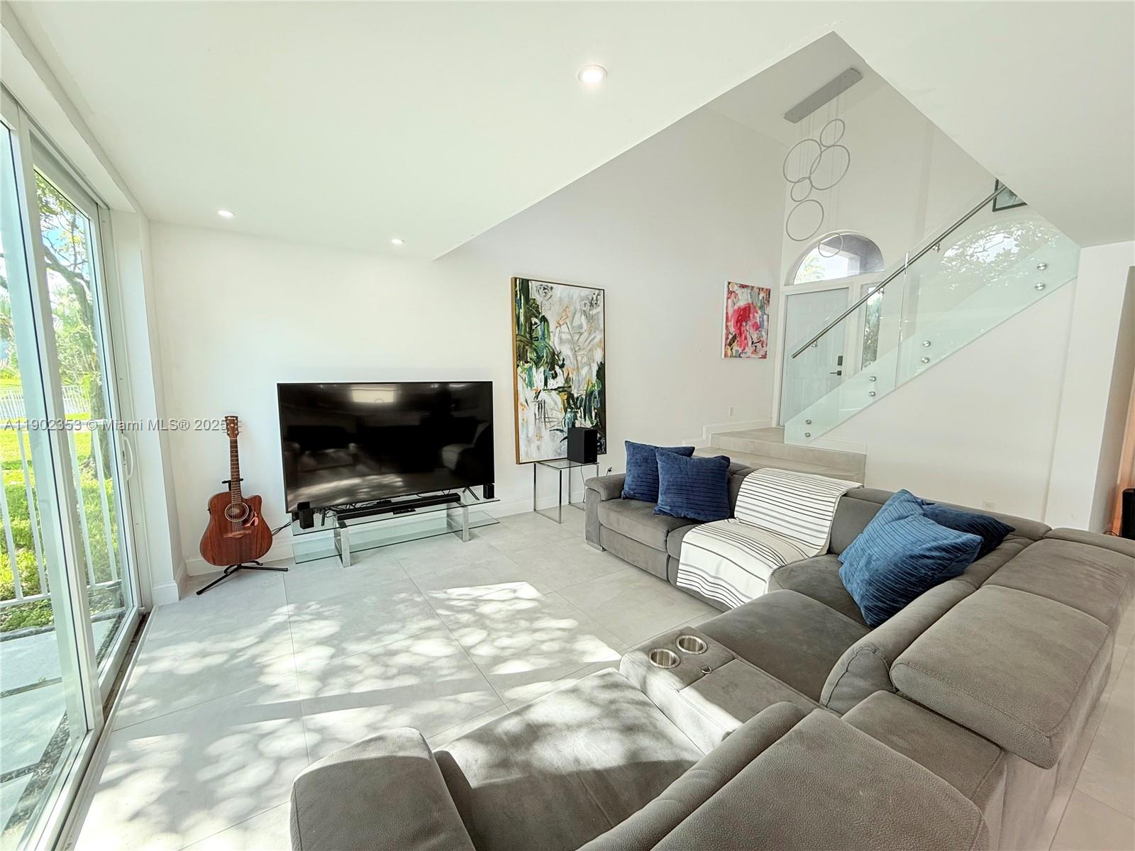 a living room with furniture and a flat screen tv