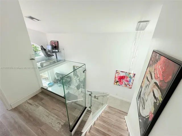 a view of a room with shelves and wooden floor