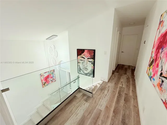 a view of an entryway with wooden floor