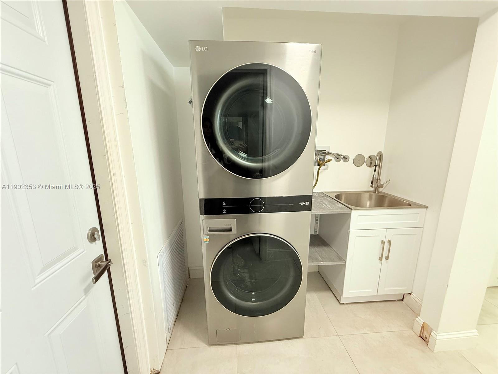 10626 Northwest 7th Street, Unit 10626 Pembroke Pines, FL 33026 - Photo 15 of 51 a close view of a washer and dryer in a bathroom