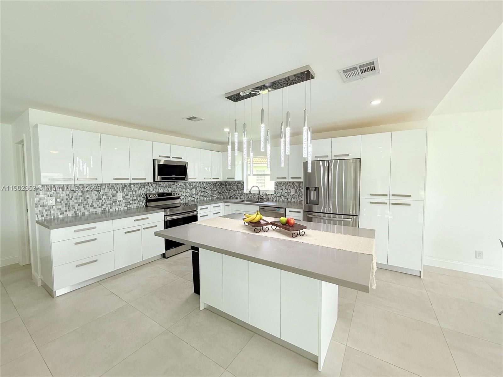 10626 Northwest 7th Street, Unit 10626 Pembroke Pines, FL 33026 - Photo 2 of 51 a kitchen with white cabinets and white appliances