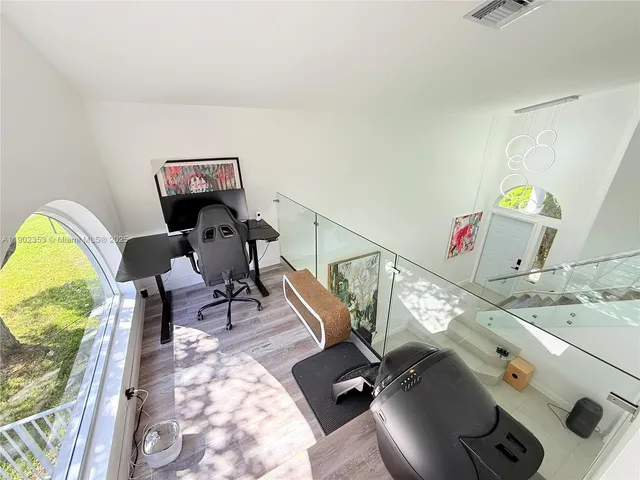 a living room with furniture and a mirror