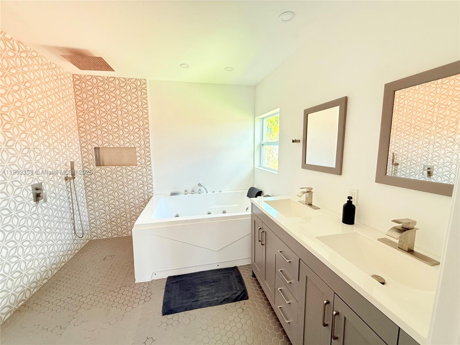 10626 Northwest 7th Street, Unit 10626 Pembroke Pines, FL 33026 - Photo 23 of 51 a spacious bathroom with a double vanity sink mirror and bathtub