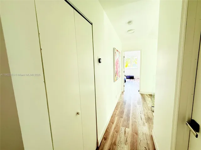 a view of a bedroom with wooden floor