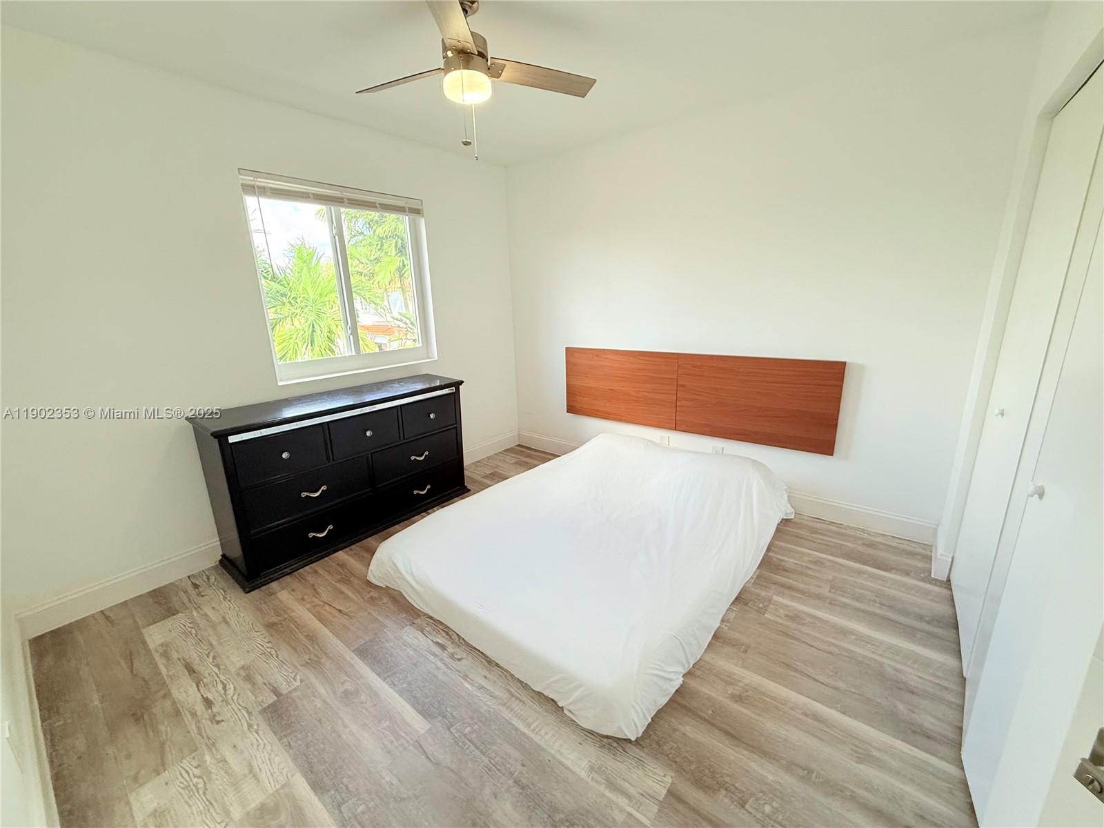 10626 Northwest 7th Street, Unit 10626 Pembroke Pines, FL 33026 - Photo 27 of 51 a bedroom with a bed and a dresser