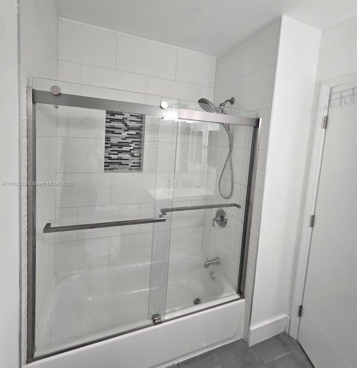 10626 Northwest 7th Street, Unit 10626 Pembroke Pines, FL 33026 - Photo 29 of 51 a bathroom with a glass shower door