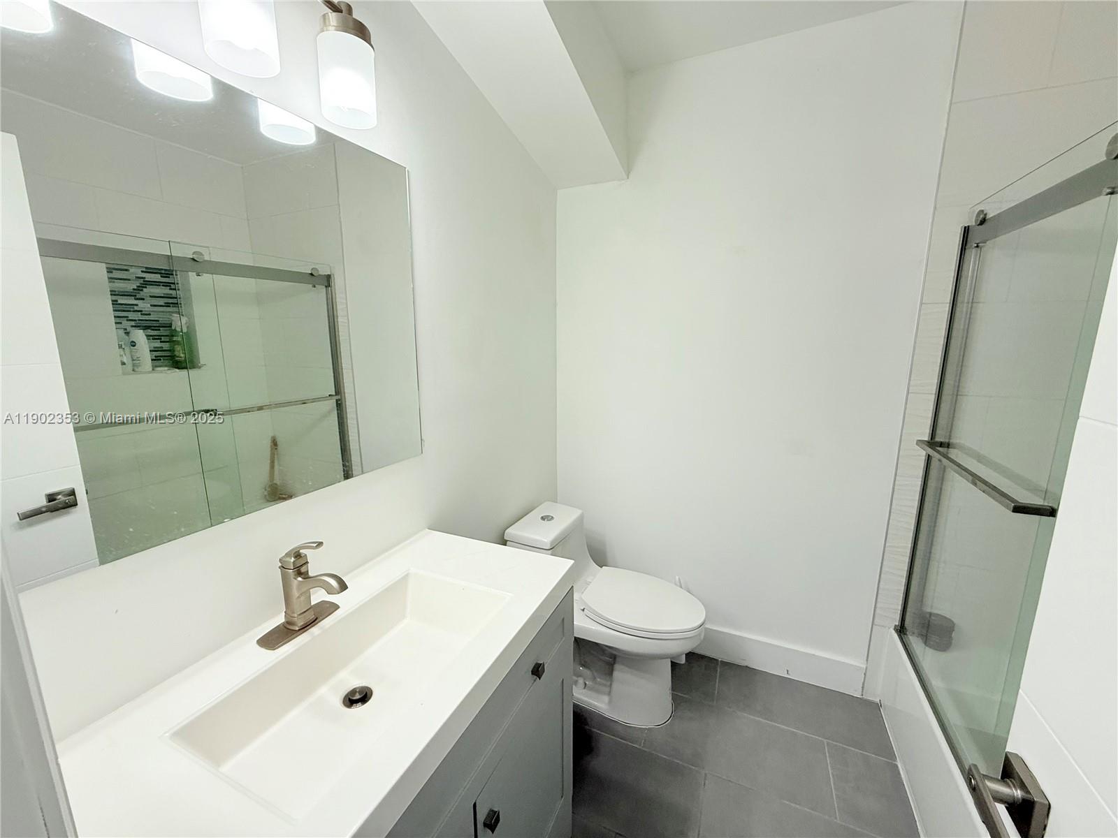 10626 Northwest 7th Street, Unit 10626 Pembroke Pines, FL 33026 - Photo 30 of 51 a bathroom with a sink toilet and shower