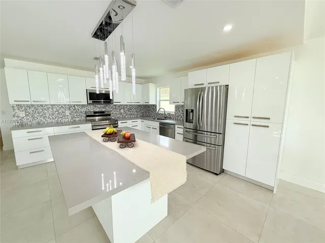 a kitchen with refrigerator and cabinets