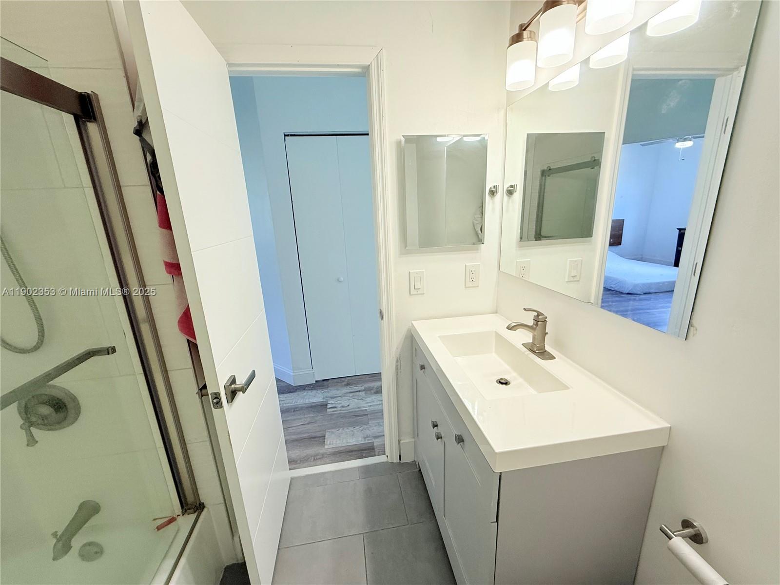 10626 Northwest 7th Street, Unit 10626 Pembroke Pines, FL 33026 - Photo 31 of 51 a bathroom with a sink a toilet a mirror and vanity