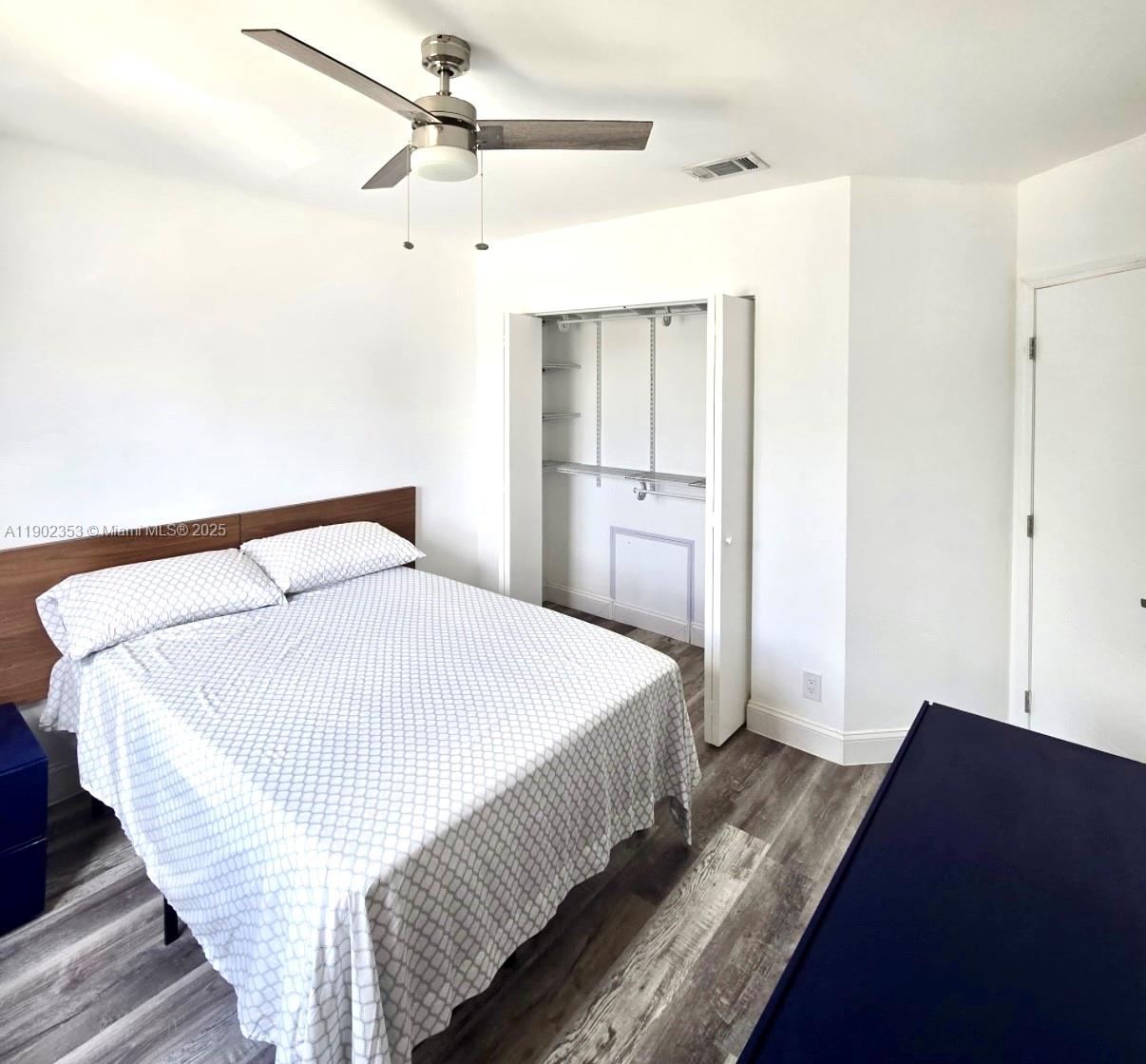 10626 Northwest 7th Street, Unit 10626 Pembroke Pines, FL 33026 - Photo 32 of 51 a bedroom with a bed and wooden floor