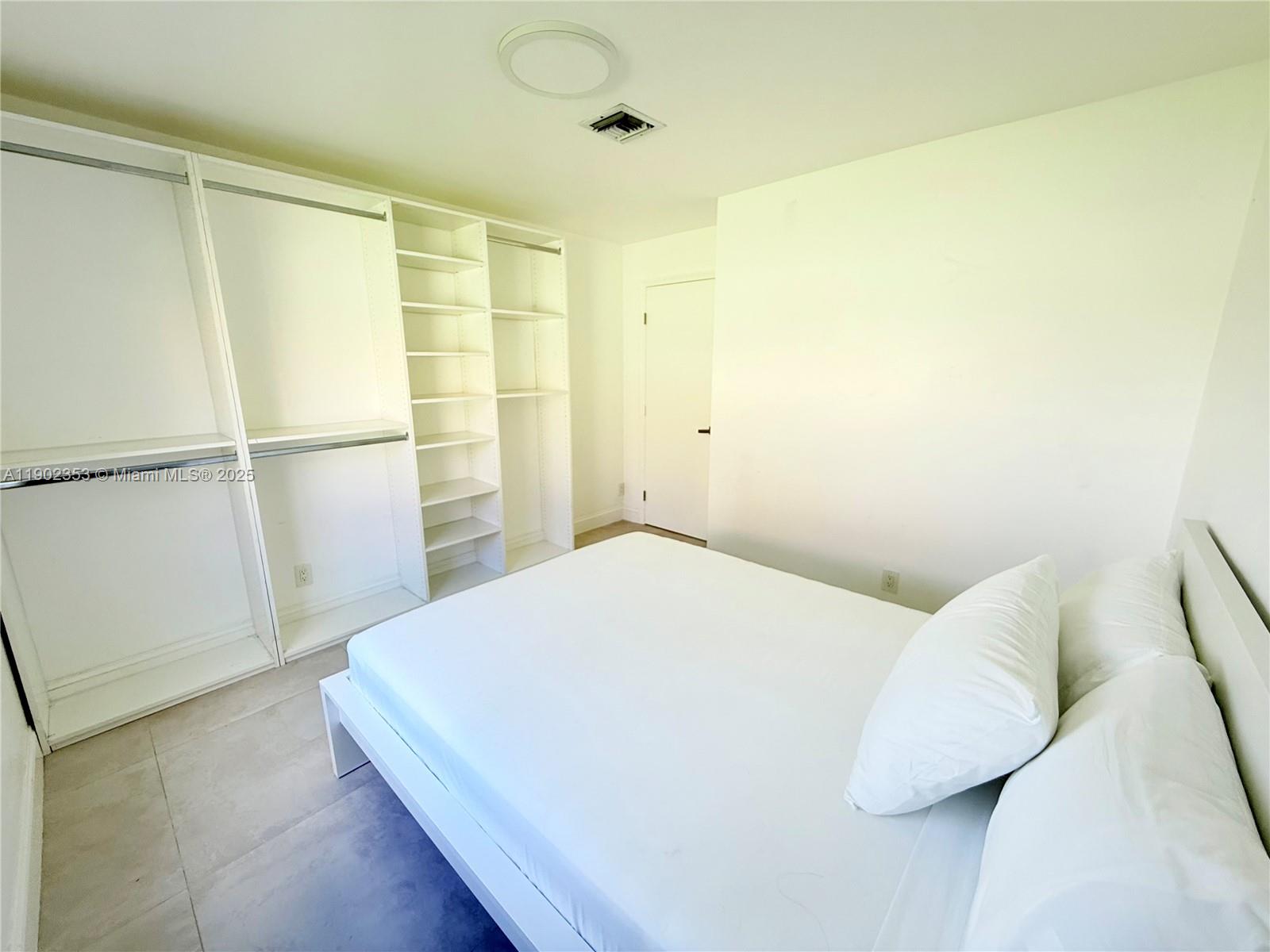 10626 Northwest 7th Street, Unit 10626 Pembroke Pines, FL 33026 - Photo 36 of 51 a bedroom with a bed and a window