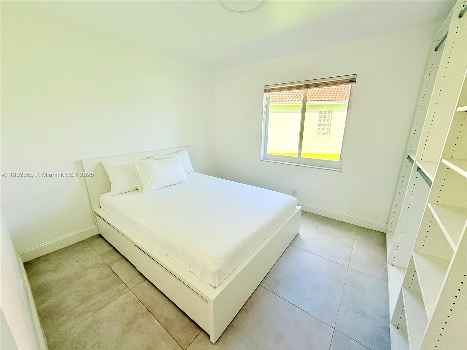 10626 Northwest 7th Street, Unit 10626 Pembroke Pines, FL 33026 - Photo 37 of 51 a bedroom with a bed and a window