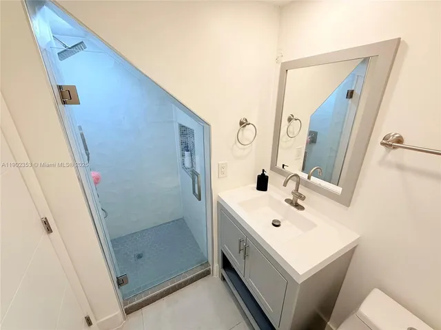 a white toilet sitting next to a bathroom sink