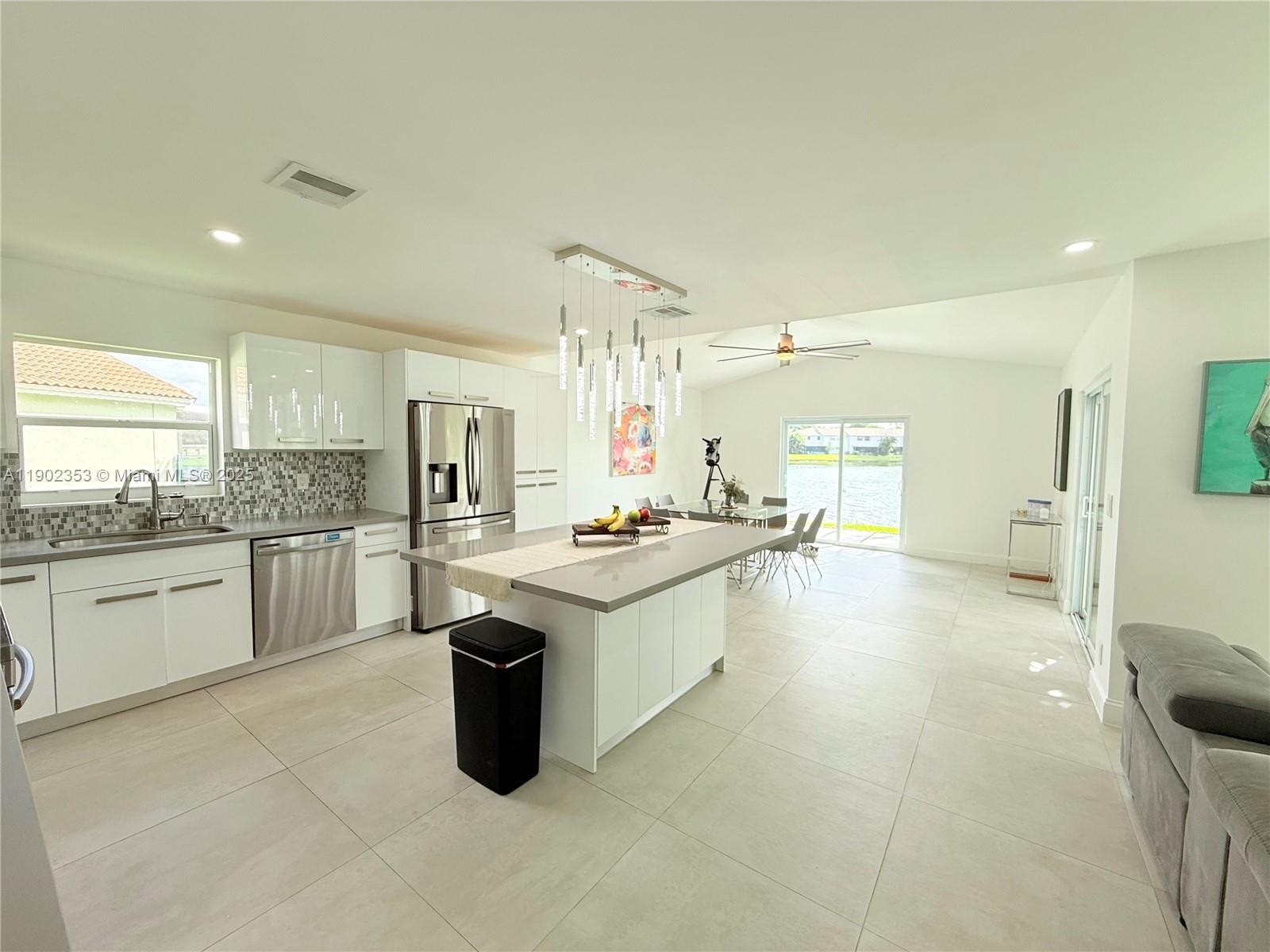 10626 Northwest 7th Street, Unit 10626 Pembroke Pines, FL 33026 - Photo 4 of 51 a large kitchen with kitchen island a sink stainless steel appliances and cabinets