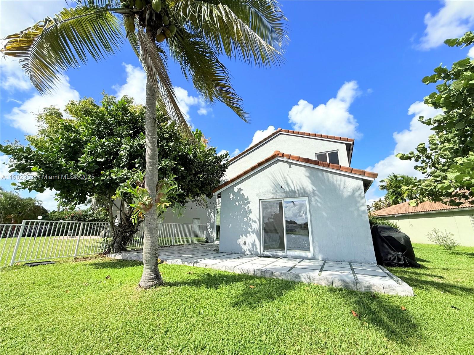 10626 Northwest 7th Street, Unit 10626 Pembroke Pines, FL 33026 - Photo 43 of 51 a front view of a house with garden