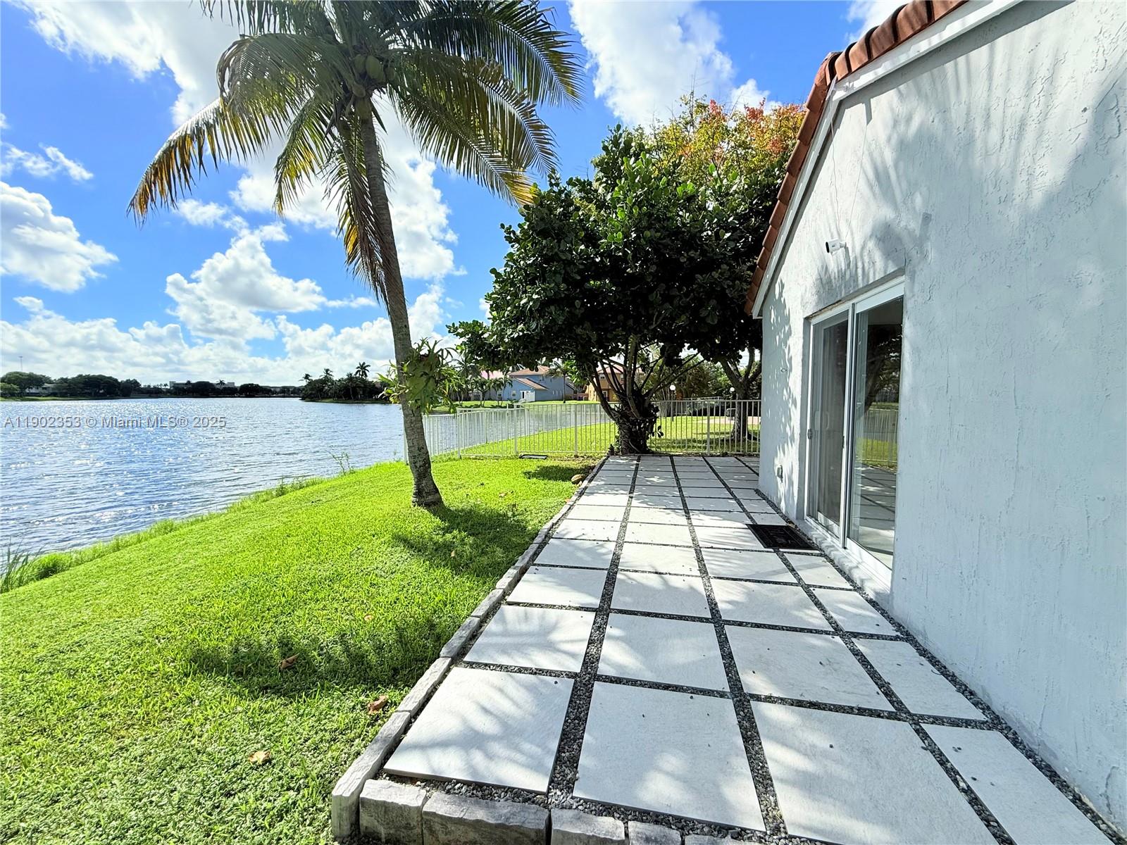 10626 Northwest 7th Street, Unit 10626 Pembroke Pines, FL 33026 - Photo 44 of 51 a view of a backyard with plants and a patio