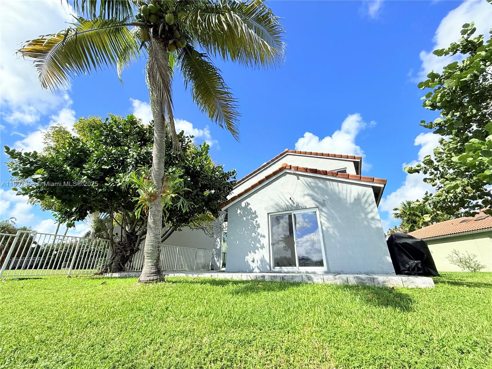 10626 Northwest 7th Street, Unit 10626 Pembroke Pines, FL 33026 - Photo 45 of 51 a front view of a house with a yard