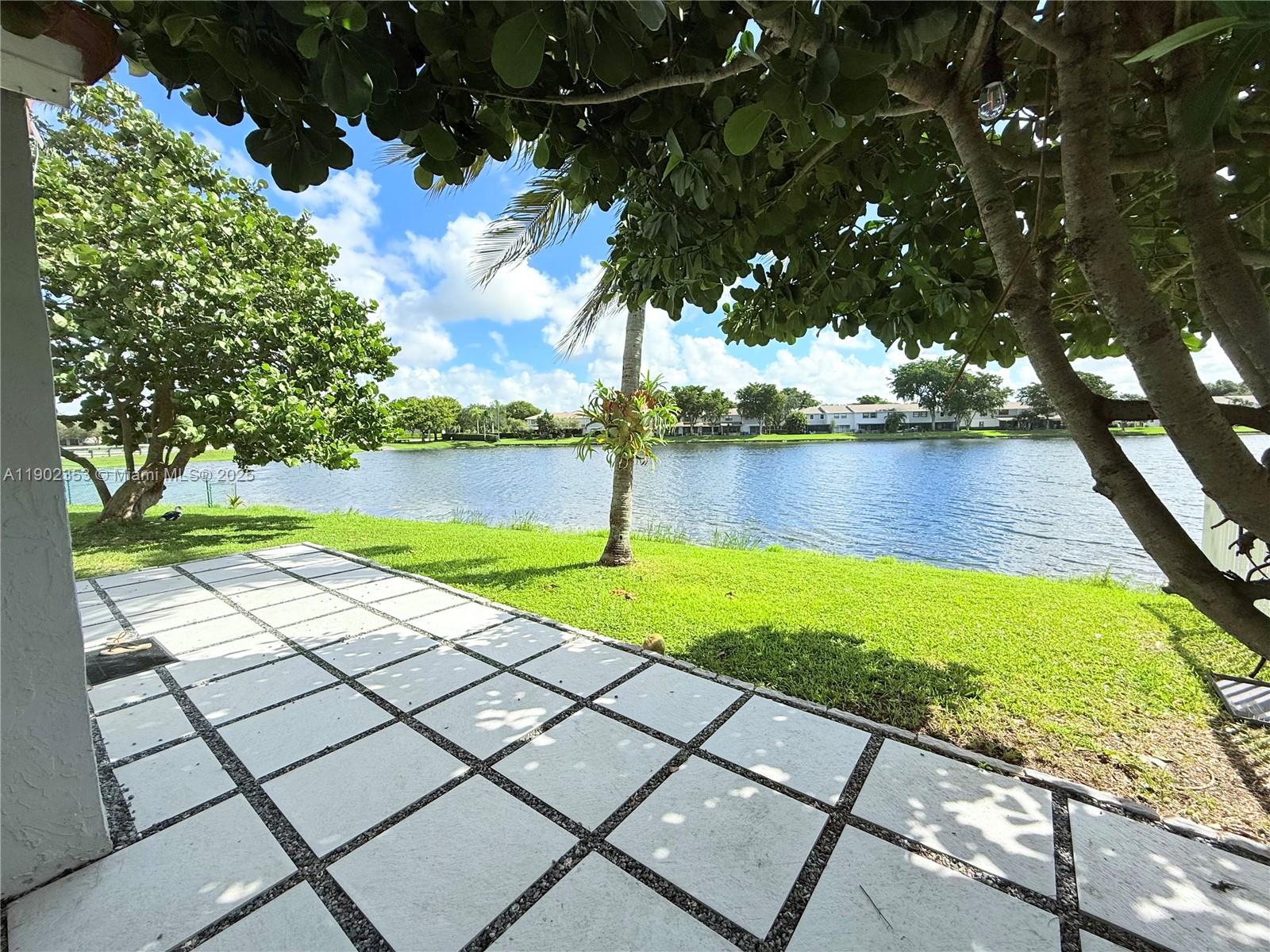 10626 Northwest 7th Street, Unit 10626 Pembroke Pines, FL 33026 - Photo 47 of 51 a view of a lake with a yard