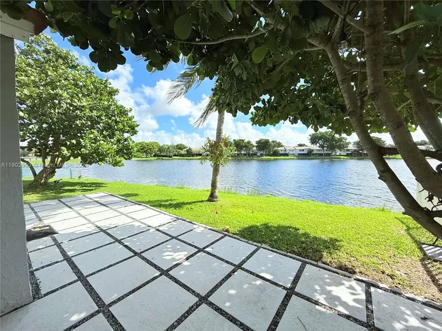 a view of a lake with houses in the back