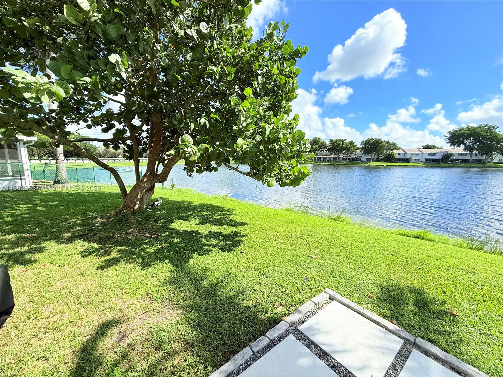 10626 Northwest 7th Street, Unit 10626 Pembroke Pines, FL 33026 - Photo 50 of 51 a view of a lake with houses in the back