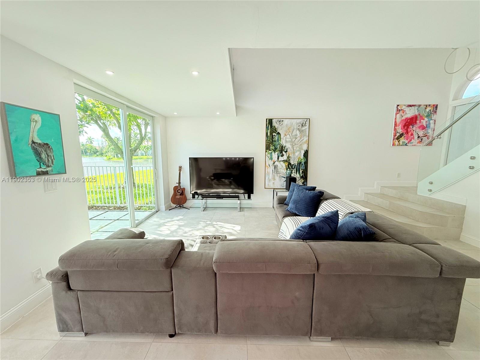 10626 Northwest 7th Street, Unit 10626 Pembroke Pines, FL 33026 - Photo 7 of 51 a living room with furniture and a flat screen tv