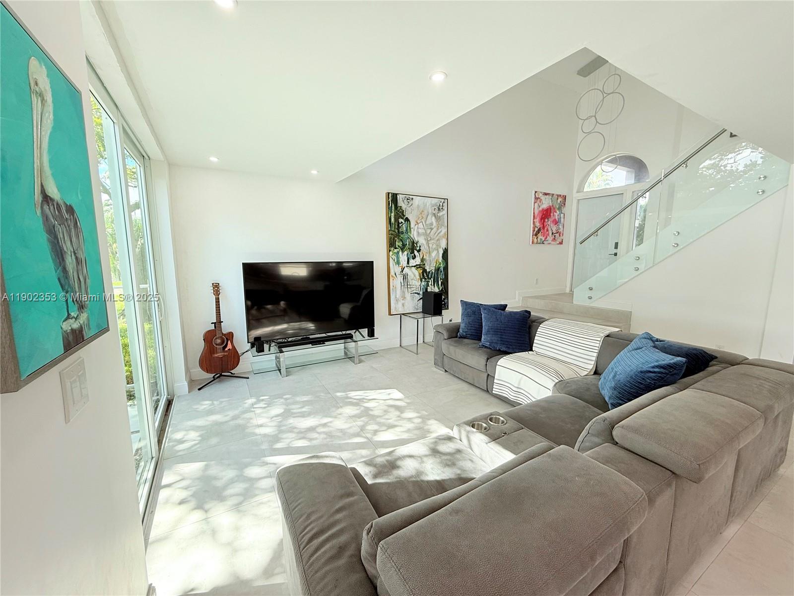 10626 Northwest 7th Street, Unit 10626 Pembroke Pines, FL 33026 - Photo 8 of 51 a living room with furniture and a flat screen tv