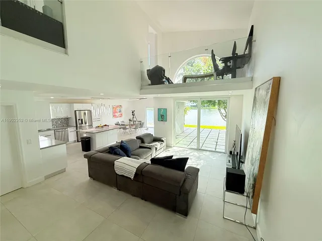 a living room with furniture and a floor to ceiling window