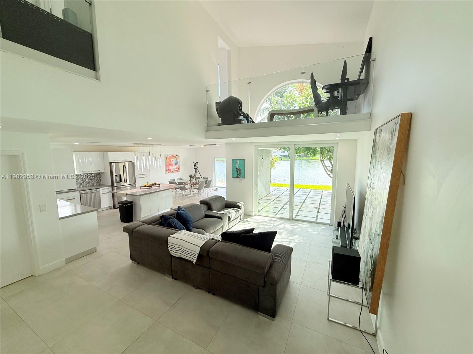 10626 Northwest 7th Street, Unit 10626 Pembroke Pines, FL 33026 - Photo 10 of 51 a living room with furniture and a floor to ceiling window