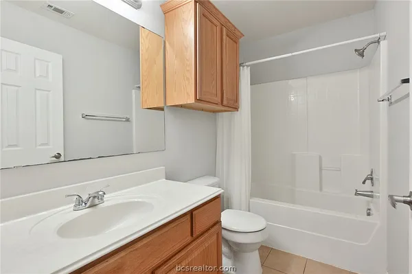 a bathroom with a sink a toilet and bathtub