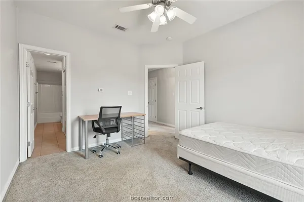 a bedroom with a bed and a chair