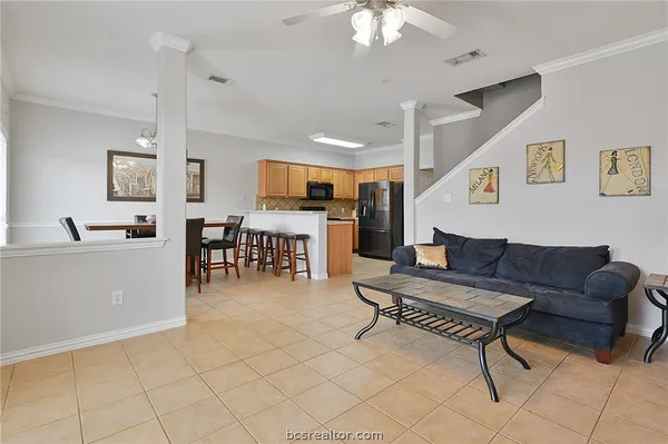 a living room with furniture a dining table and kitchen view