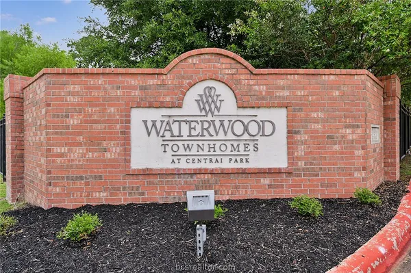 a sign on the side of a brick building