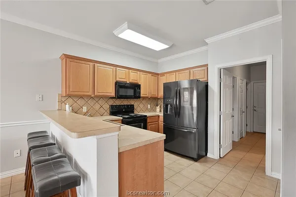 a kitchen with a refrigerator sink and microwave