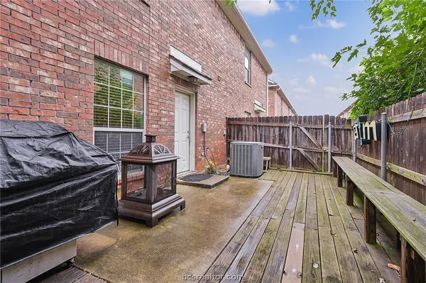 a view of balcony with wooden floor and iron fence