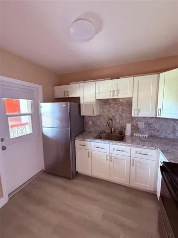 a kitchen with refrigerator and window