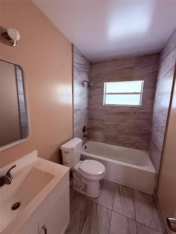 a bathroom with a sink a toilet and bathtub