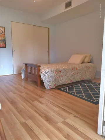 a view of a hallway with wooden floor and stairs